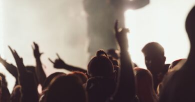 Dancing concert while singer is performing surrounded by lights