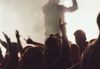 Dancing concert while singer is performing surrounded by lights